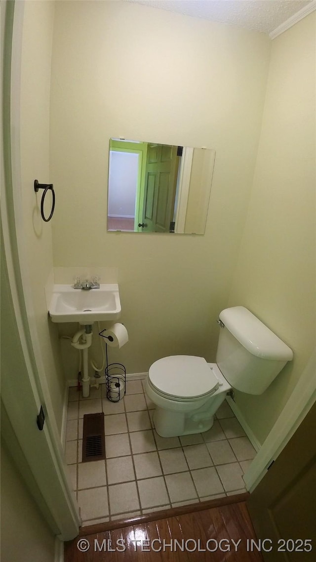 bathroom featuring hardwood / wood-style flooring and toilet