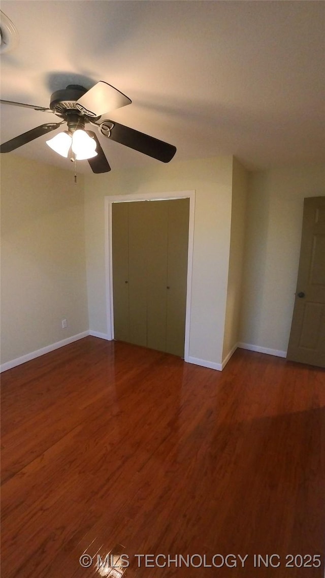 unfurnished bedroom with ceiling fan, hardwood / wood-style floors, and a closet