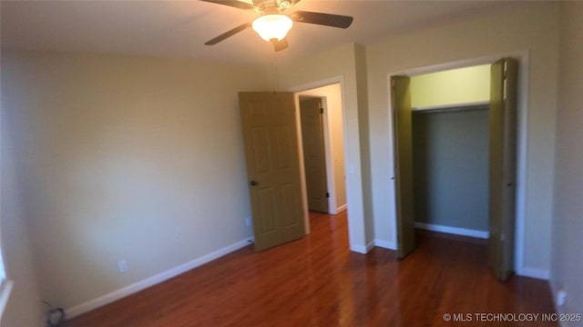 unfurnished bedroom with ceiling fan and dark hardwood / wood-style floors