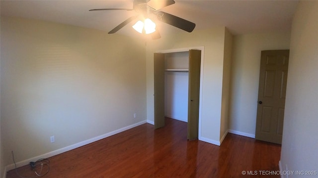 unfurnished bedroom featuring dark wood-type flooring, a closet, and ceiling fan