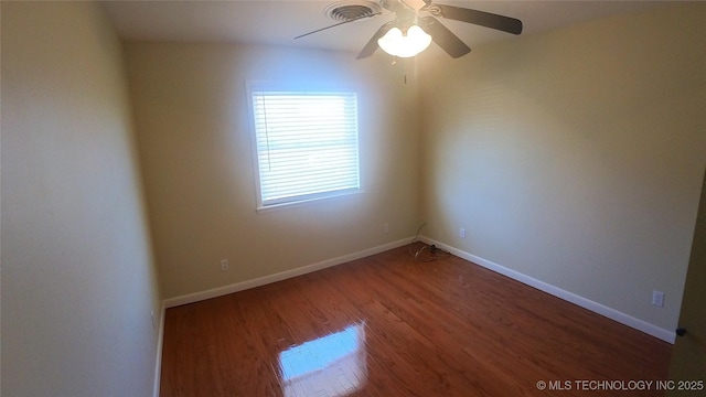 spare room with ceiling fan and wood-type flooring