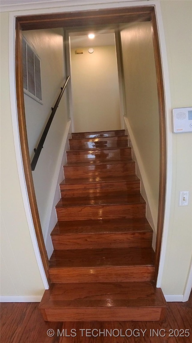 stairs with hardwood / wood-style flooring