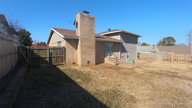 rear view of property with a yard