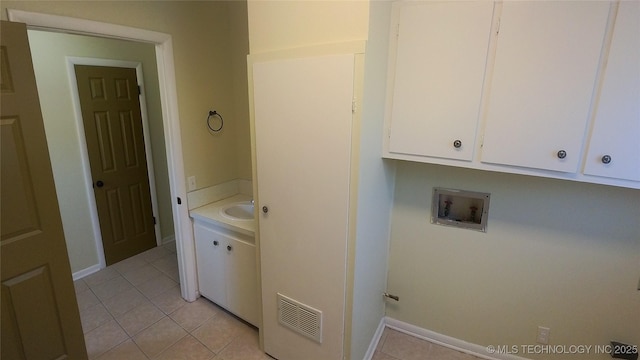 laundry area featuring cabinets, washer hookup, and light tile patterned floors