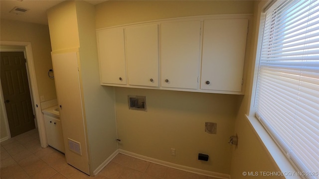 laundry area featuring cabinets, light tile patterned flooring, electric dryer hookup, and washer hookup