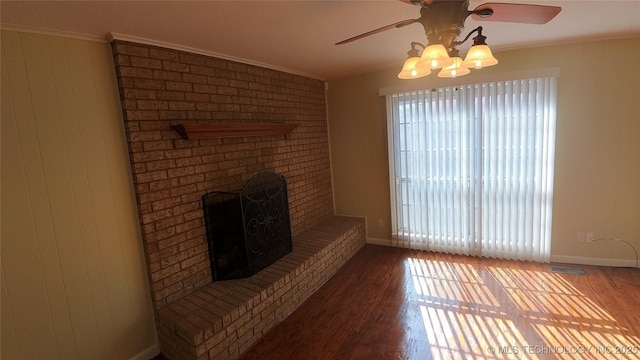 living room featuring ornamental molding, hardwood / wood-style floors, ceiling fan, and a fireplace