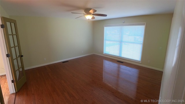 unfurnished room with dark wood-type flooring and ceiling fan