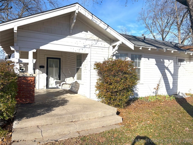 rear view of house with covered porch