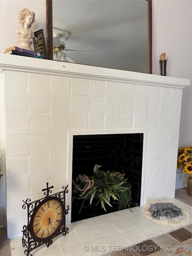 interior details with a fireplace and ceiling fan