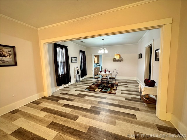 dining area featuring crown molding, an inviting chandelier, and wood finished floors