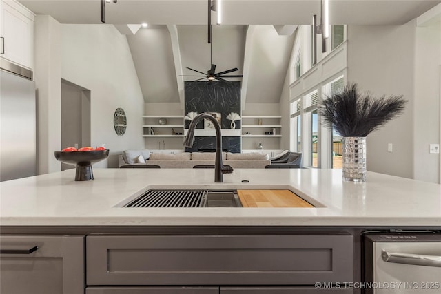 kitchen with white cabinetry, lofted ceiling, sink, gray cabinetry, and ceiling fan