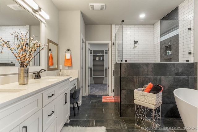 bathroom featuring tile patterned floors, vanity, and plus walk in shower