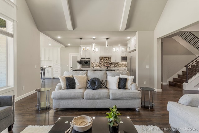 living room featuring sink, dark hardwood / wood-style flooring, and lofted ceiling with beams