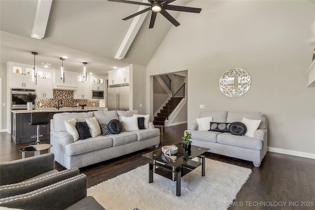 living room with ceiling fan, dark hardwood / wood-style flooring, high vaulted ceiling, and beam ceiling