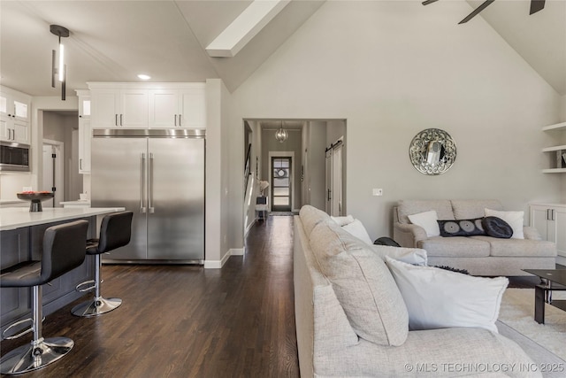 living room featuring ceiling fan, dark wood-type flooring, and high vaulted ceiling