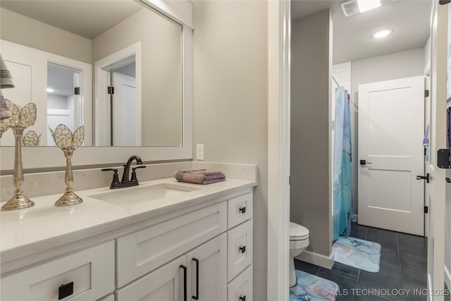 bathroom featuring vanity, tile patterned floors, and toilet