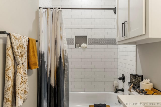 bathroom with shower / bath combo with shower curtain