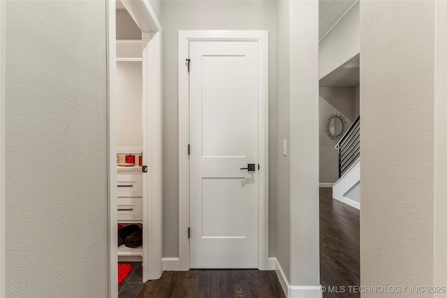 hallway with dark hardwood / wood-style flooring