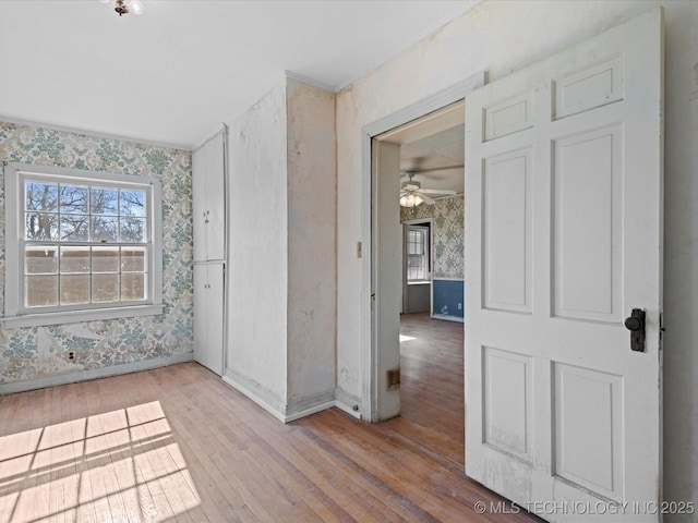 unfurnished room featuring crown molding and light hardwood / wood-style flooring