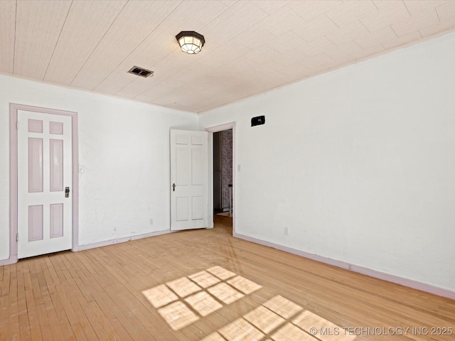 spare room with wood-type flooring