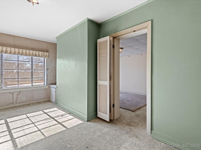 unfurnished bedroom featuring ornamental molding and a closet