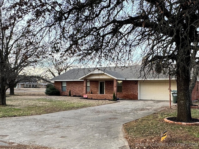 ranch-style house with a garage and a front lawn