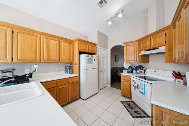 kitchen with sink, light tile patterned floors, and white appliances