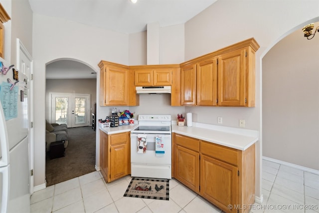 kitchen featuring white appliances and light carpet