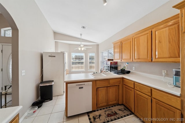 kitchen with sink, white appliances, kitchen peninsula, and light tile patterned floors