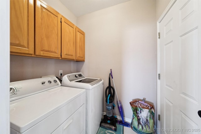 laundry room with cabinets and washing machine and dryer