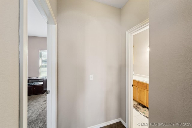 hallway featuring light colored carpet