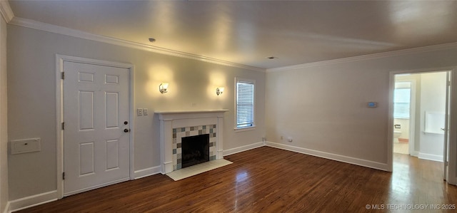 unfurnished living room with a tiled fireplace, crown molding, and dark hardwood / wood-style floors