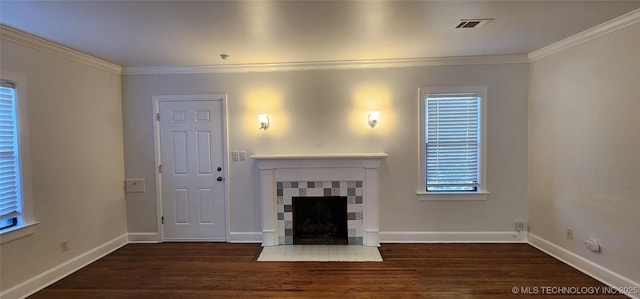 unfurnished living room featuring a tile fireplace, crown molding, and dark hardwood / wood-style floors