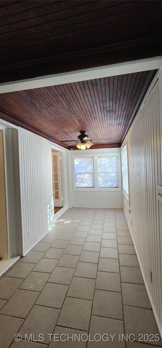 unfurnished sunroom with ceiling fan and wooden ceiling