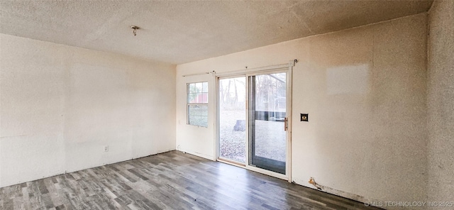 empty room featuring hardwood / wood-style floors and a textured ceiling