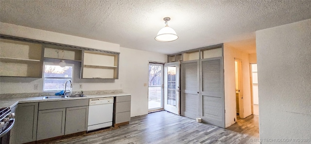 kitchen featuring a wealth of natural light, sink, pendant lighting, and white dishwasher