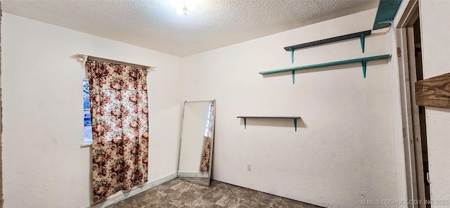 unfurnished room featuring a textured ceiling