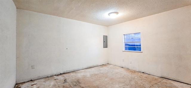 unfurnished room featuring electric panel and a textured ceiling