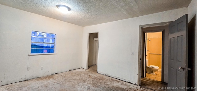 unfurnished room with a textured ceiling