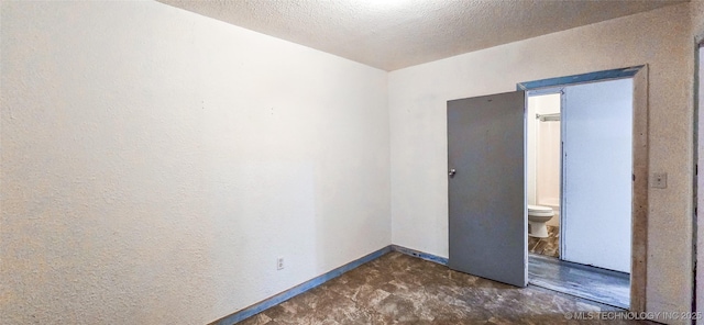 spare room featuring a textured ceiling