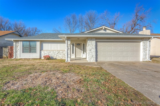 ranch-style home featuring a garage and a front lawn