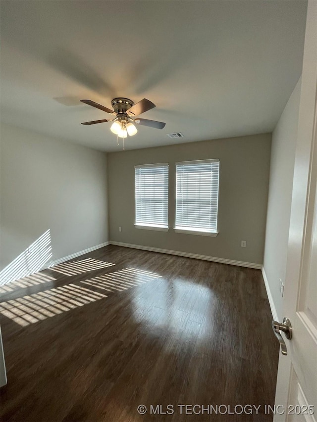 unfurnished room with dark hardwood / wood-style floors and ceiling fan