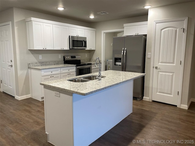 kitchen with stainless steel appliances, an island with sink, dark wood-type flooring, and white cabinetry