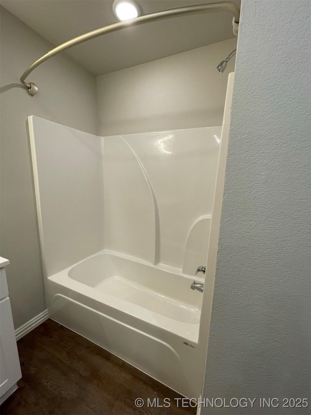 bathroom with hardwood / wood-style floors and shower / bathing tub combination