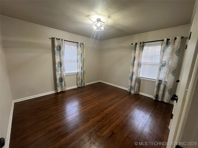 spare room with dark hardwood / wood-style floors