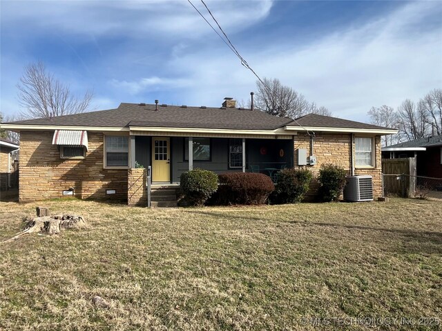 ranch-style house featuring central AC and a front lawn