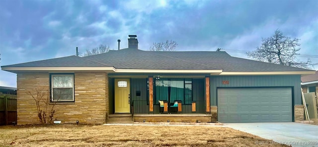 ranch-style house featuring a garage, a front yard, and a porch