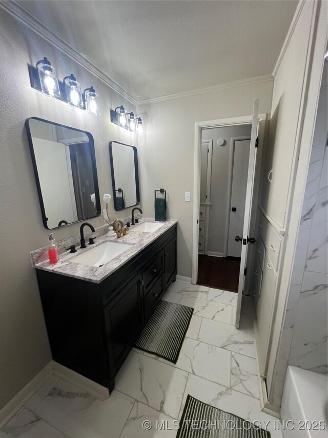 bathroom with crown molding, a tub to relax in, and vanity