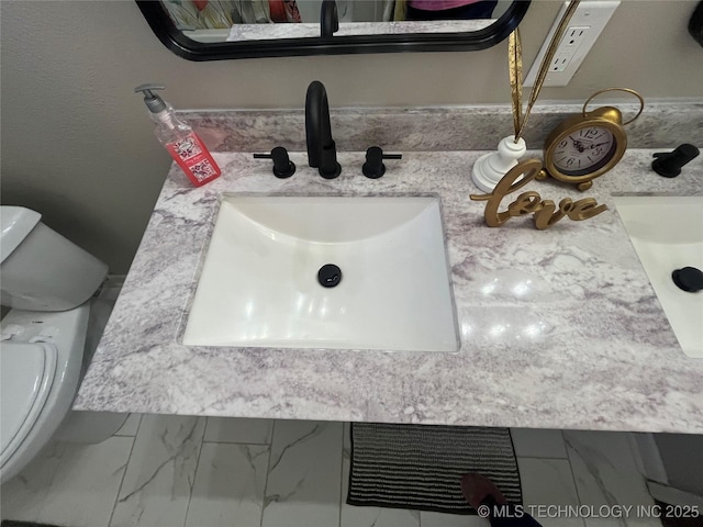 bathroom featuring vanity and toilet