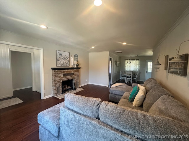 living room featuring ornamental molding, a fireplace, and dark hardwood / wood-style flooring